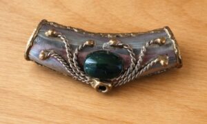 This was found in an old woman’s jewelry box. It’s open at each end and hollow inside.
