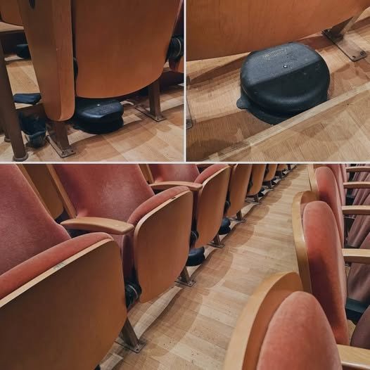 What are these metal discs under many seats at a concert hall?